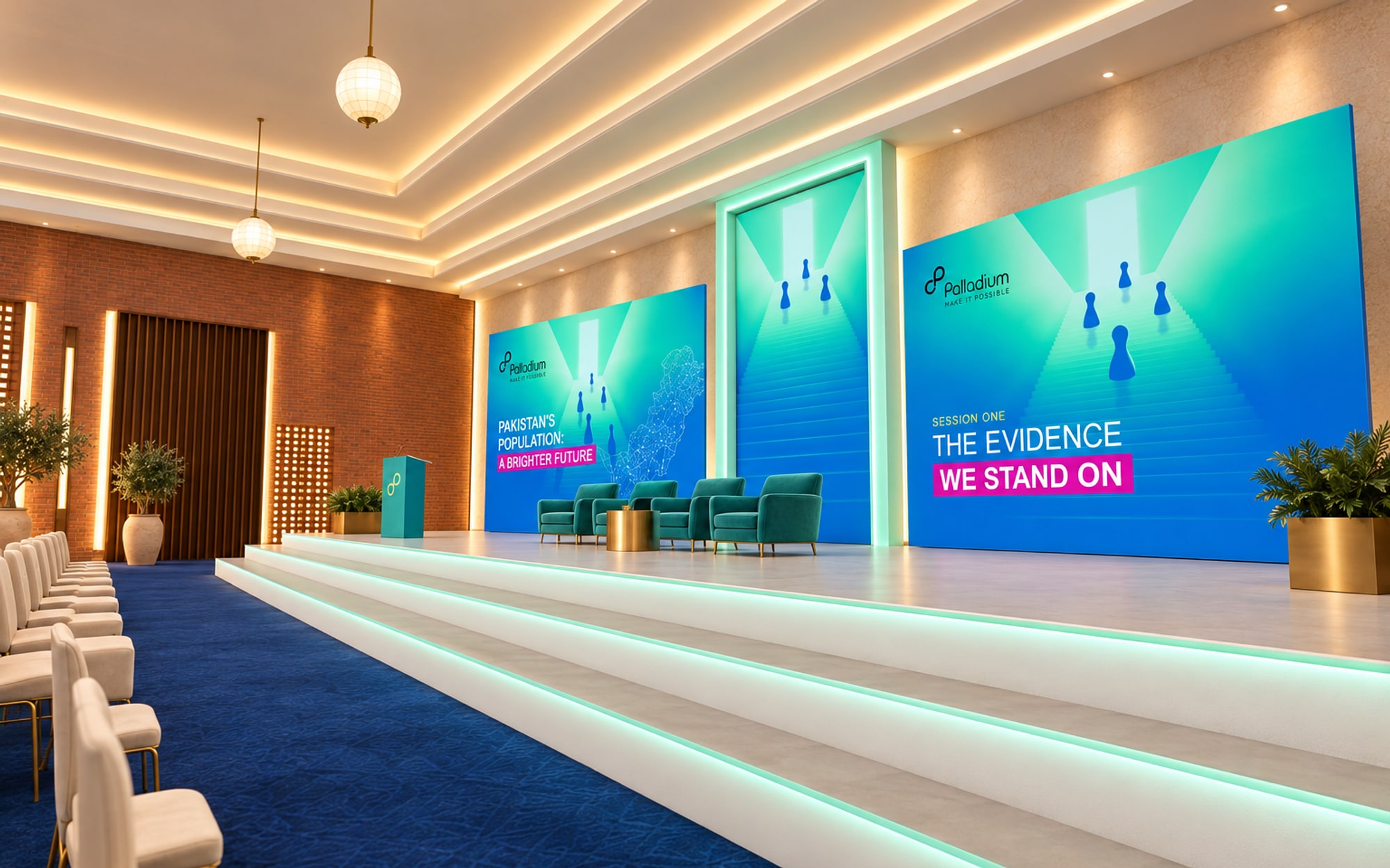 The stage from the front corner: three lit steps across its whole width, four teal armchairs and a lectern, the door screen and the wing screens standing on the stage floor