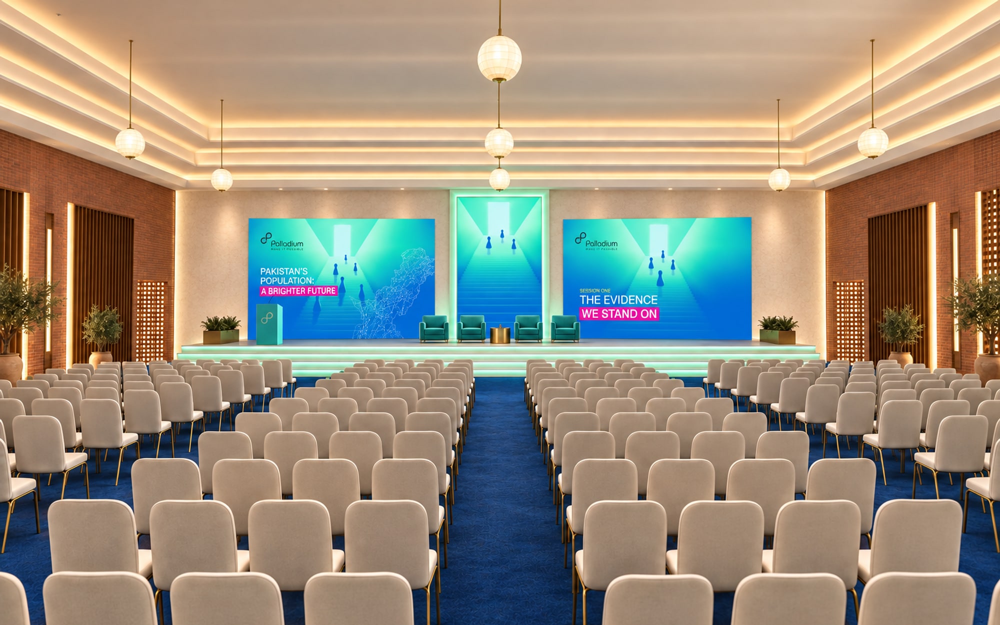 A ballroom seen from the back: rows of ivory chairs on blue carpet facing a stage fronted by three lit steps, a tall door-shaped screen at its centre and a wide screen either side, globe lamps overhead