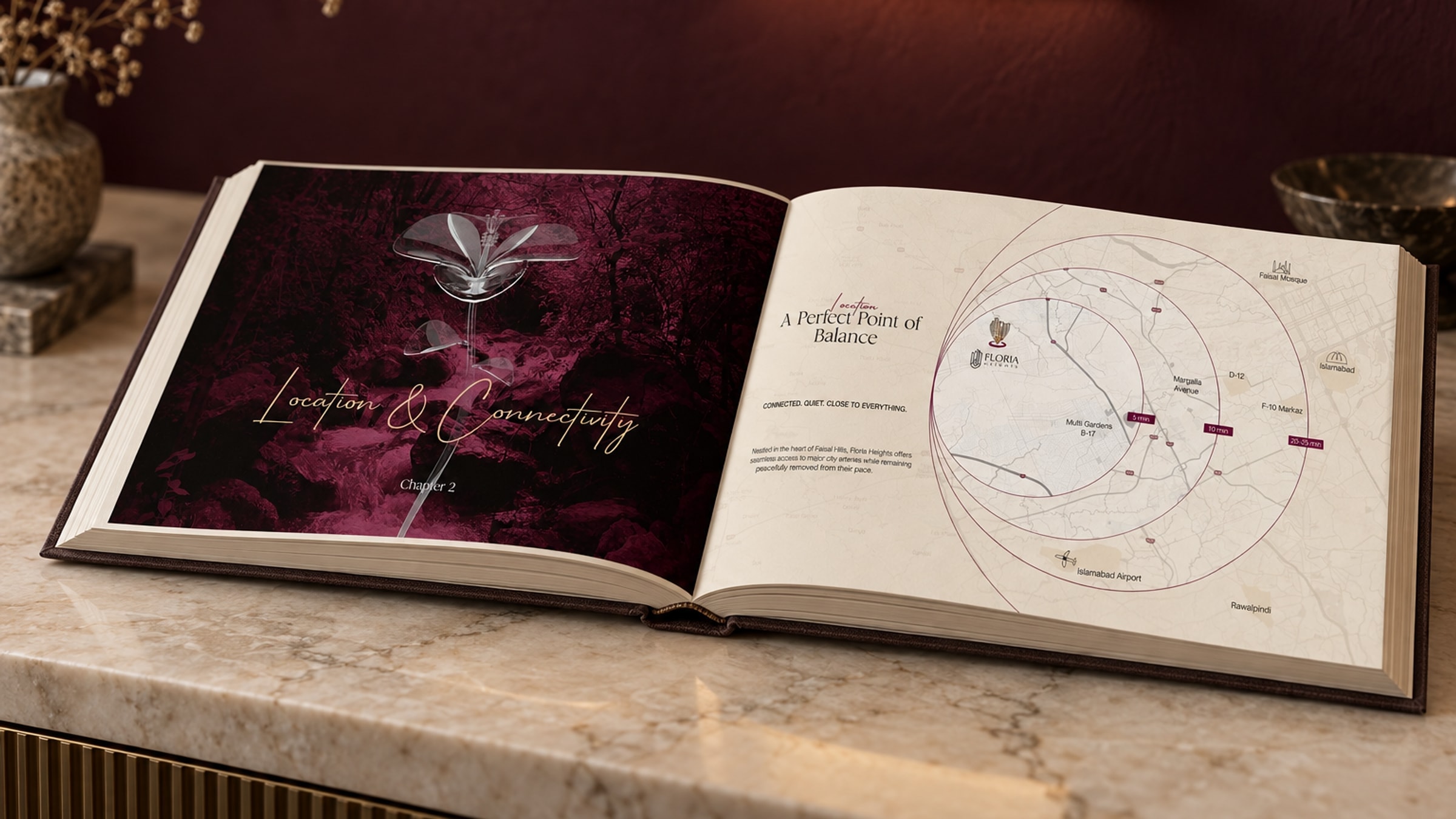 The book open on a marble console: the Location chapter opener on the left page, the ringed map on the right