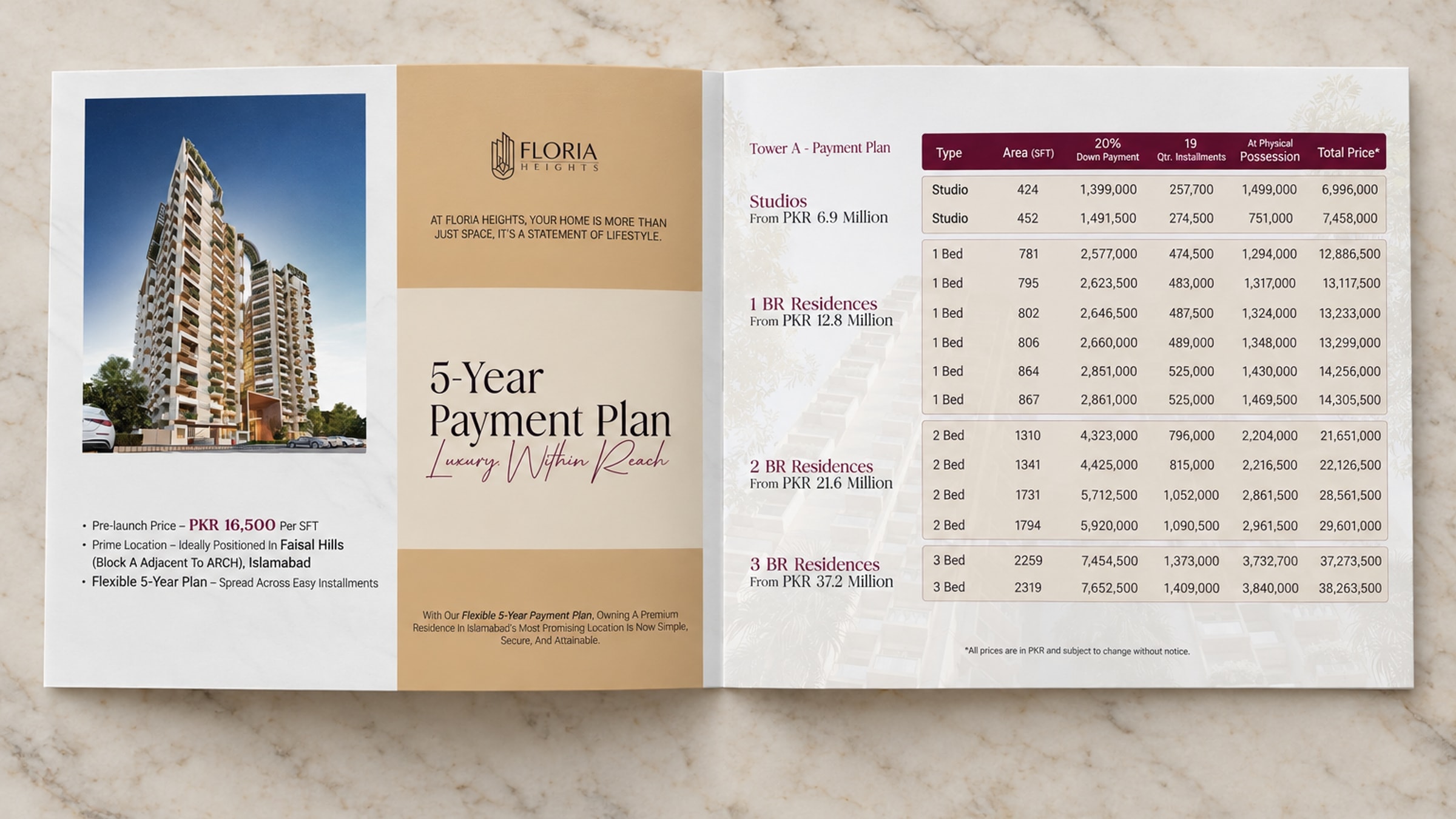 The payment plan folder open on marble, shot from above: the tower and the words 5-Year Payment Plan on the left page, the schedule by unit type on the right