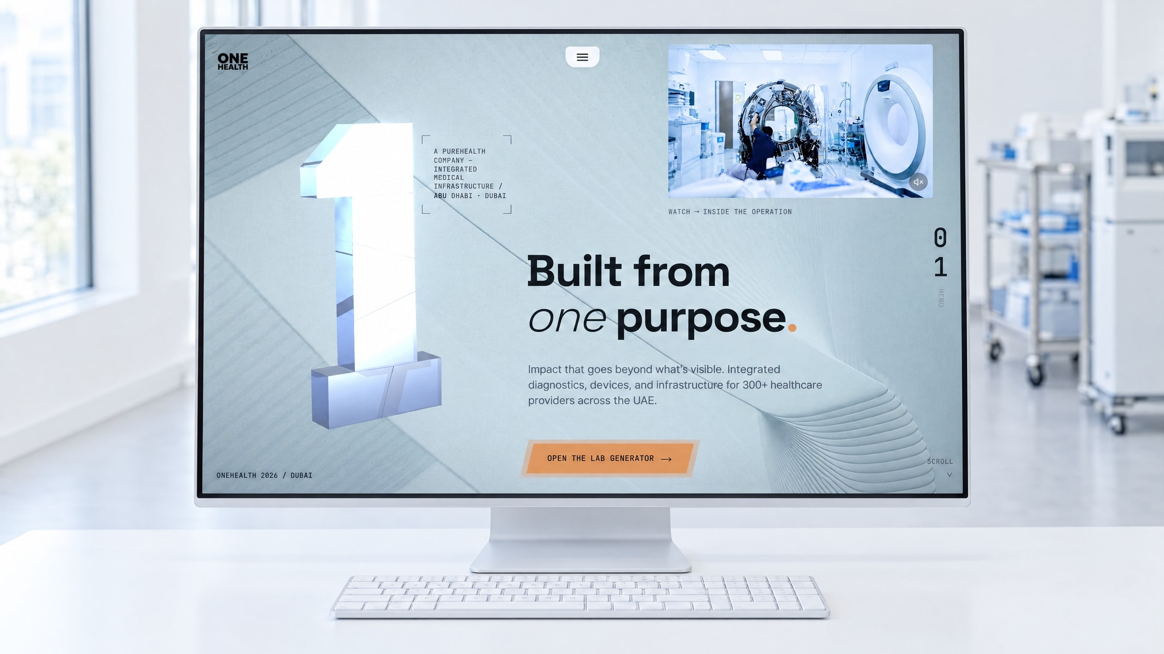 The OneHealth homepage on a large desktop display in a bright clinical office, a stainless steel trolley and laboratory equipment out of focus behind it