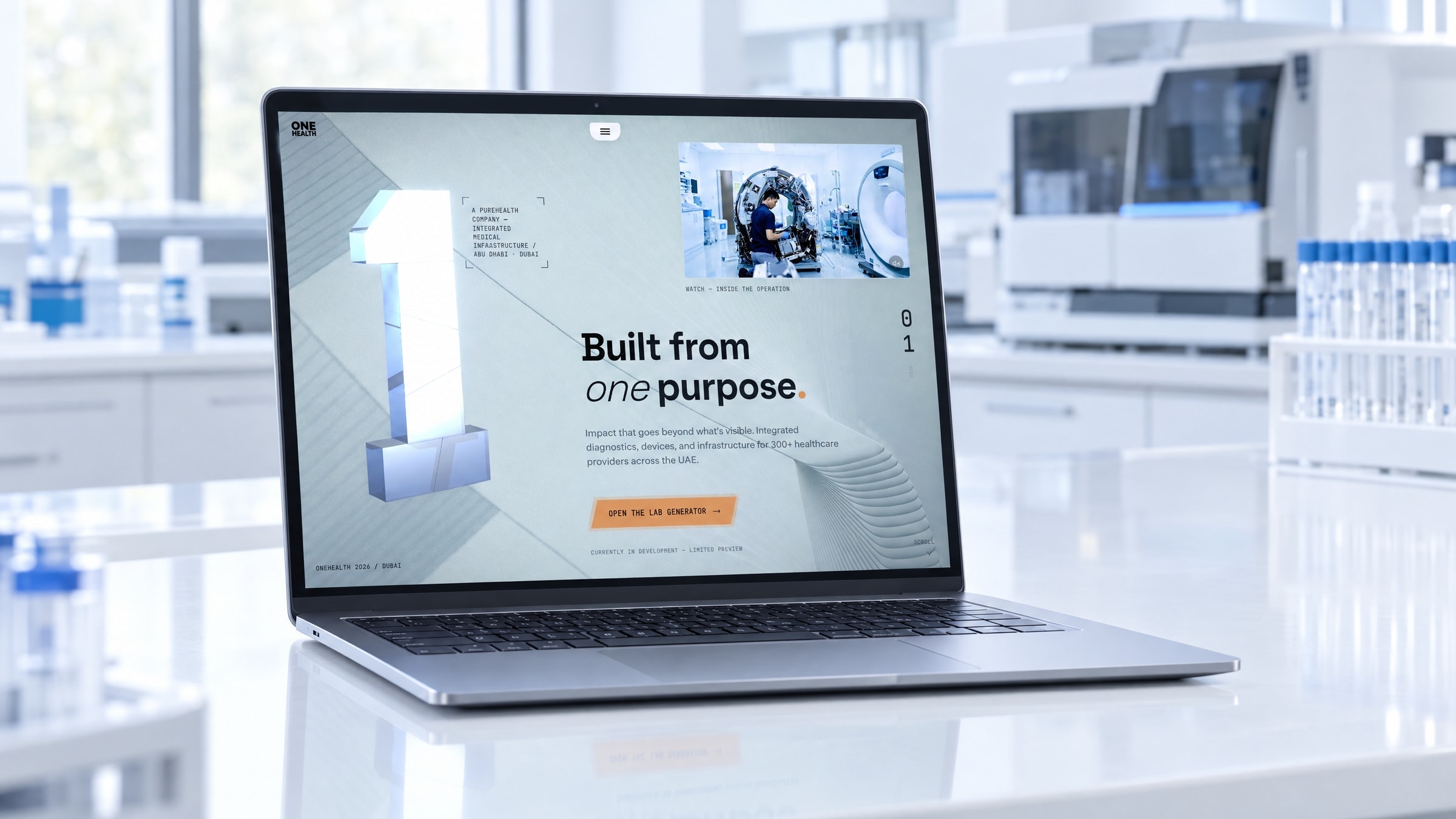 The homepage on a laptop open on a white laboratory bench, an analyser and a rack of vials out of focus behind it