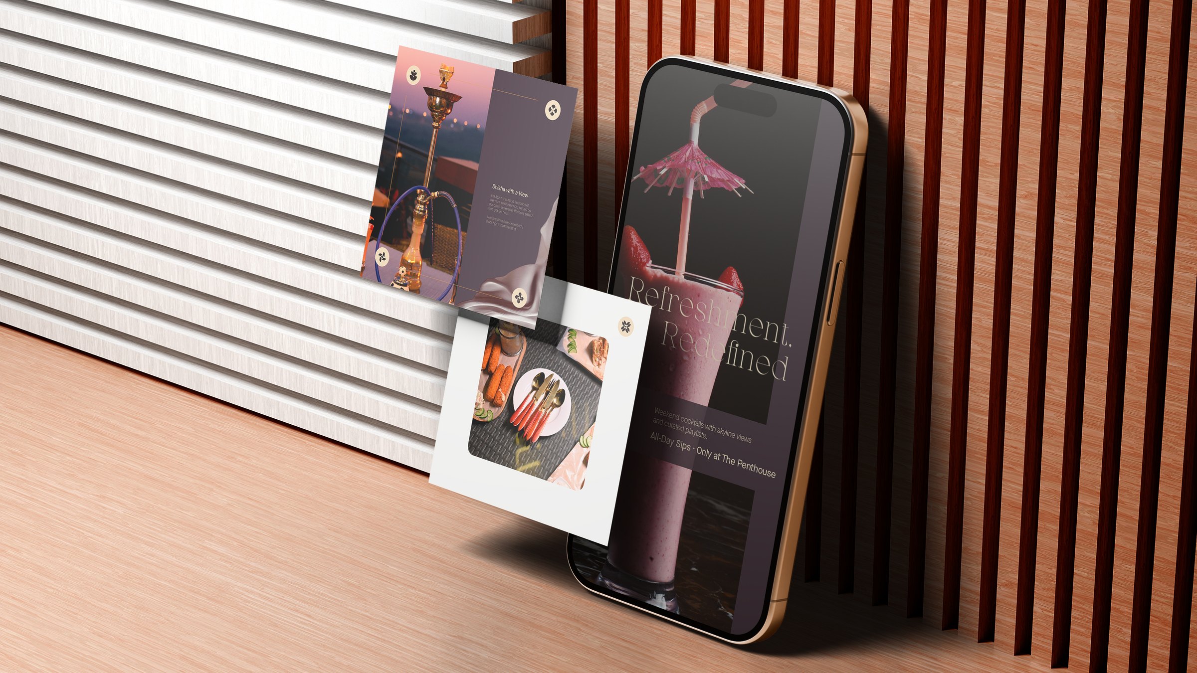 The Penthouse social system shown on a phone alongside two printed cards, lit warmly against wood.