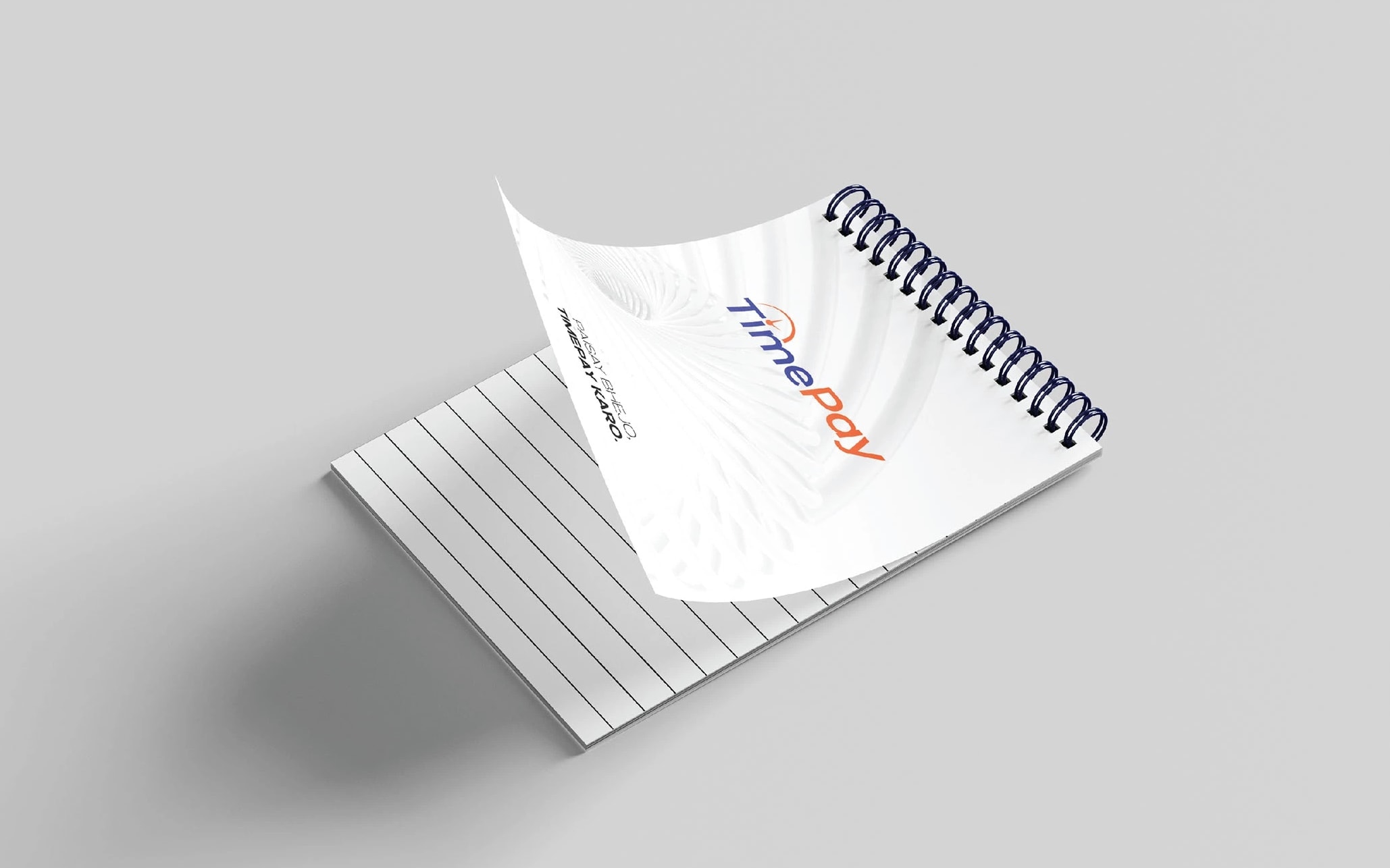 A spiral-bound notepad with the logotype and a faint spiral pattern on its cover, a page lifting